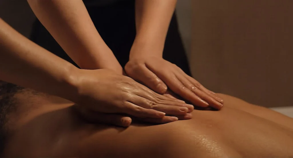 3 hands massaging naked back