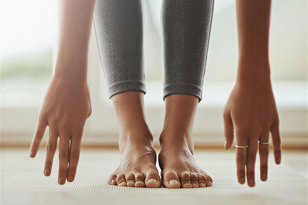 Bending forward stretching by taking hands to feet