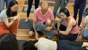 Pascal demonstrating shoulder movement with a student during a Feldenkrais Awareness Through Movement workshop