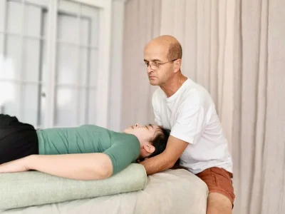 Pascal giving Functional Integration session to a lady lying on her back